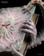 Necronomicon collectible statue — creature holding grimoire, Masters of Madness